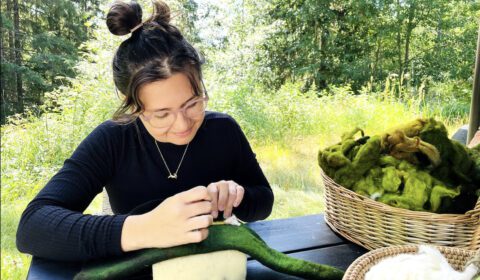Person needle felting a sauna hat at workshop in Muurame