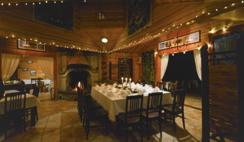 Cozy interior of Kivitasku Event Venue Villa with dining setup and fireplace